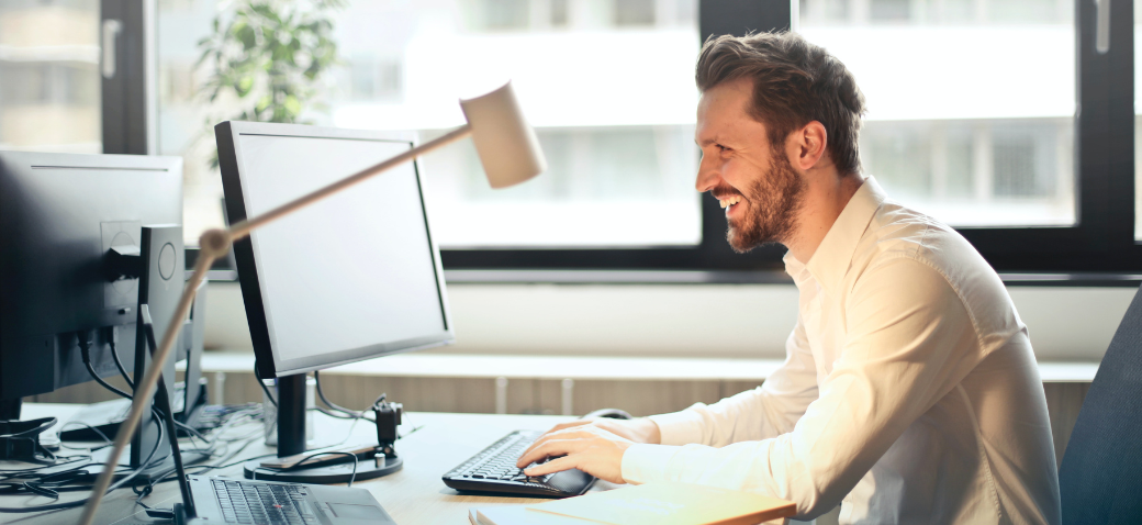 person in fron of a computer laughing